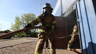 Fire science students practice during live burn simulation.