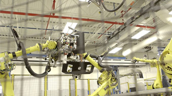 Honda factory robotic arms building car parts.