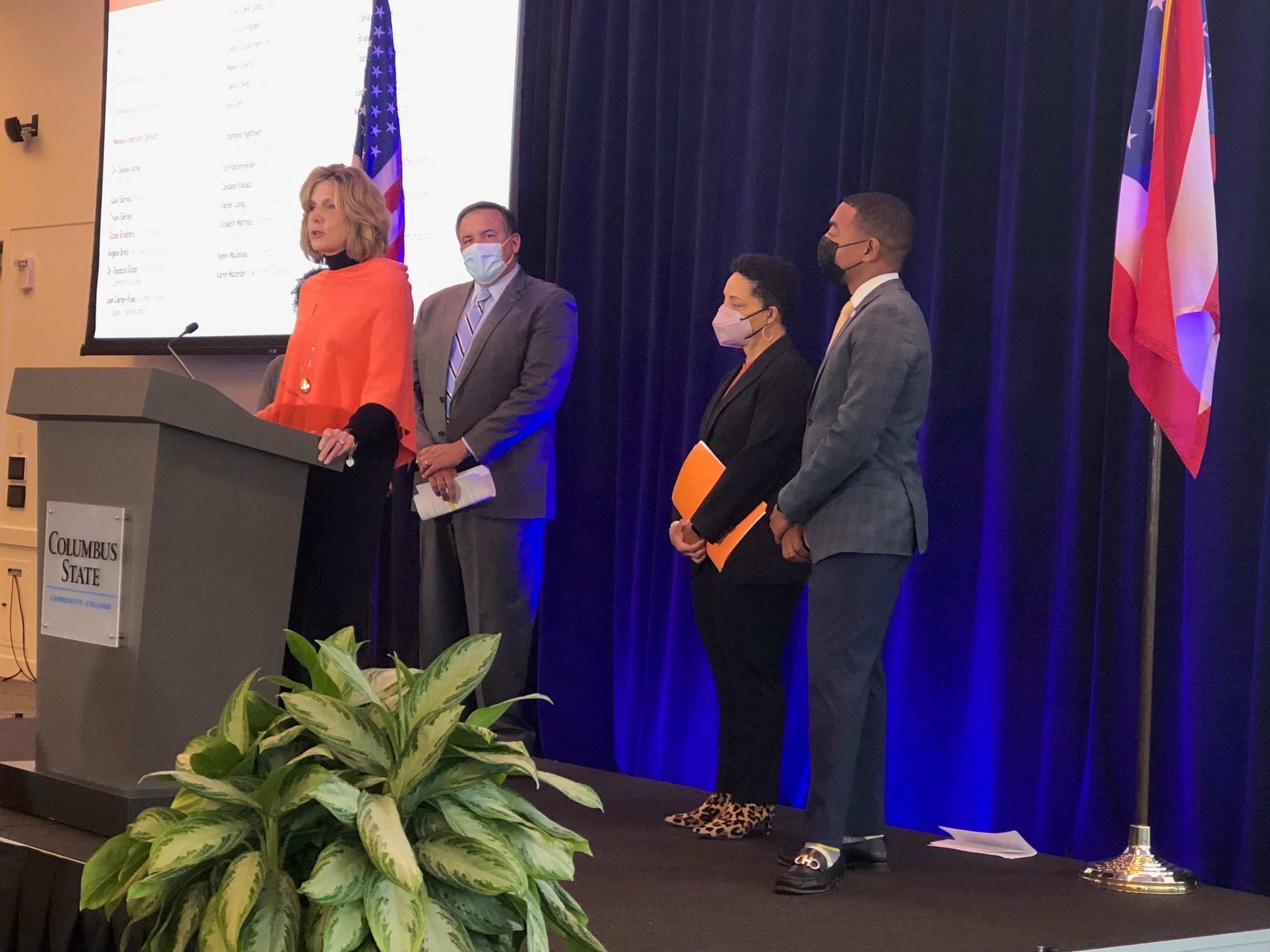 Rebecca Butler, executive vice president at Columbus State, speaks at the podium. Behind her, left to right, Columbus Mayor Andrew Ginther, Christie Angel, president and CEO of the YWCA, and Shannon Hardin, Columbus City Council president. 