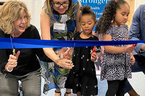 Chldren help cut the ribbon at the Center for Early Learning event