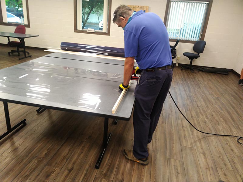 
Barry Miliser, lead maintenance, constructs a vinyl barrier. They are used in classrooms, offfices, and public spaces.

