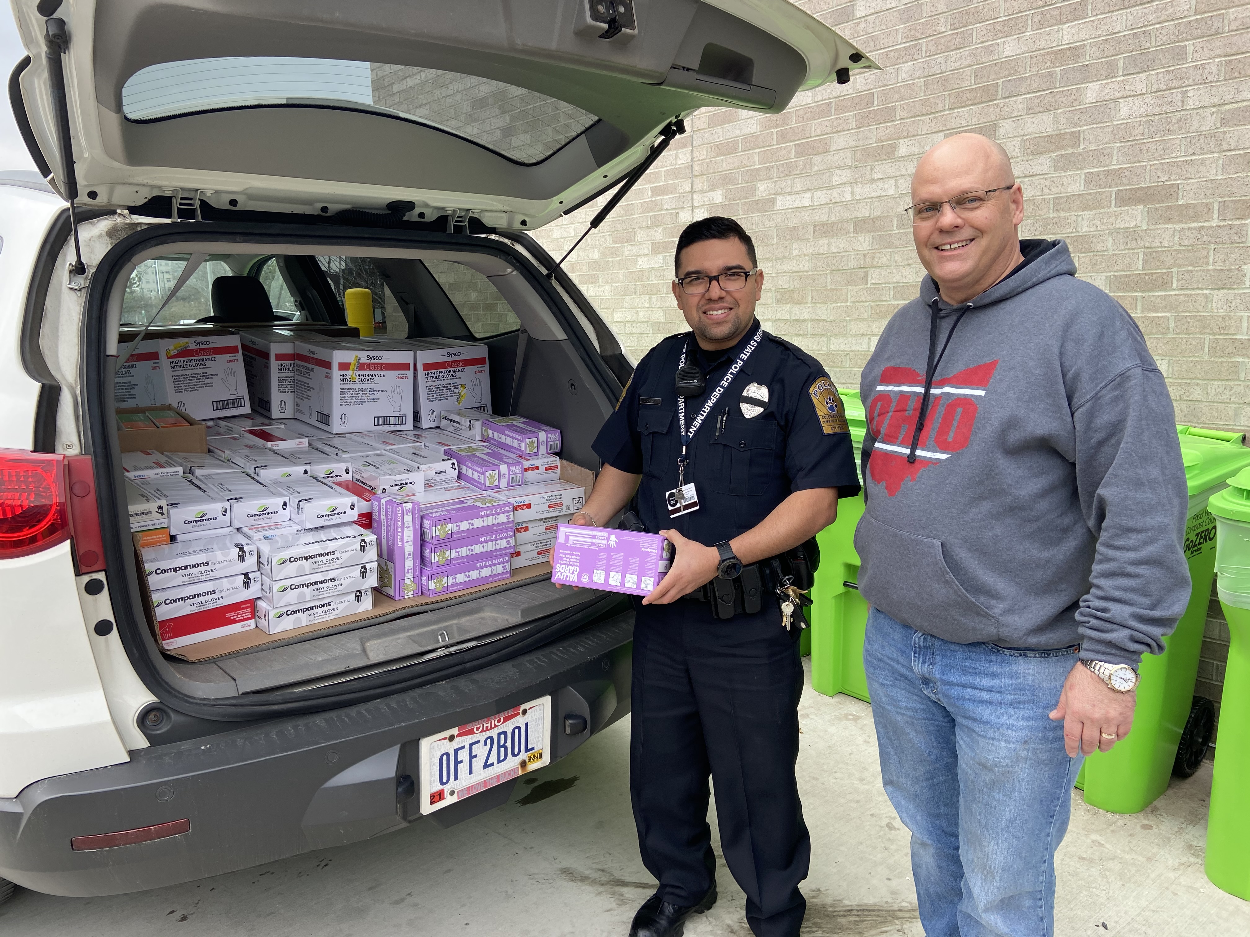 Marty Maliwesky and Officer Sanchez with the donation of supplies,