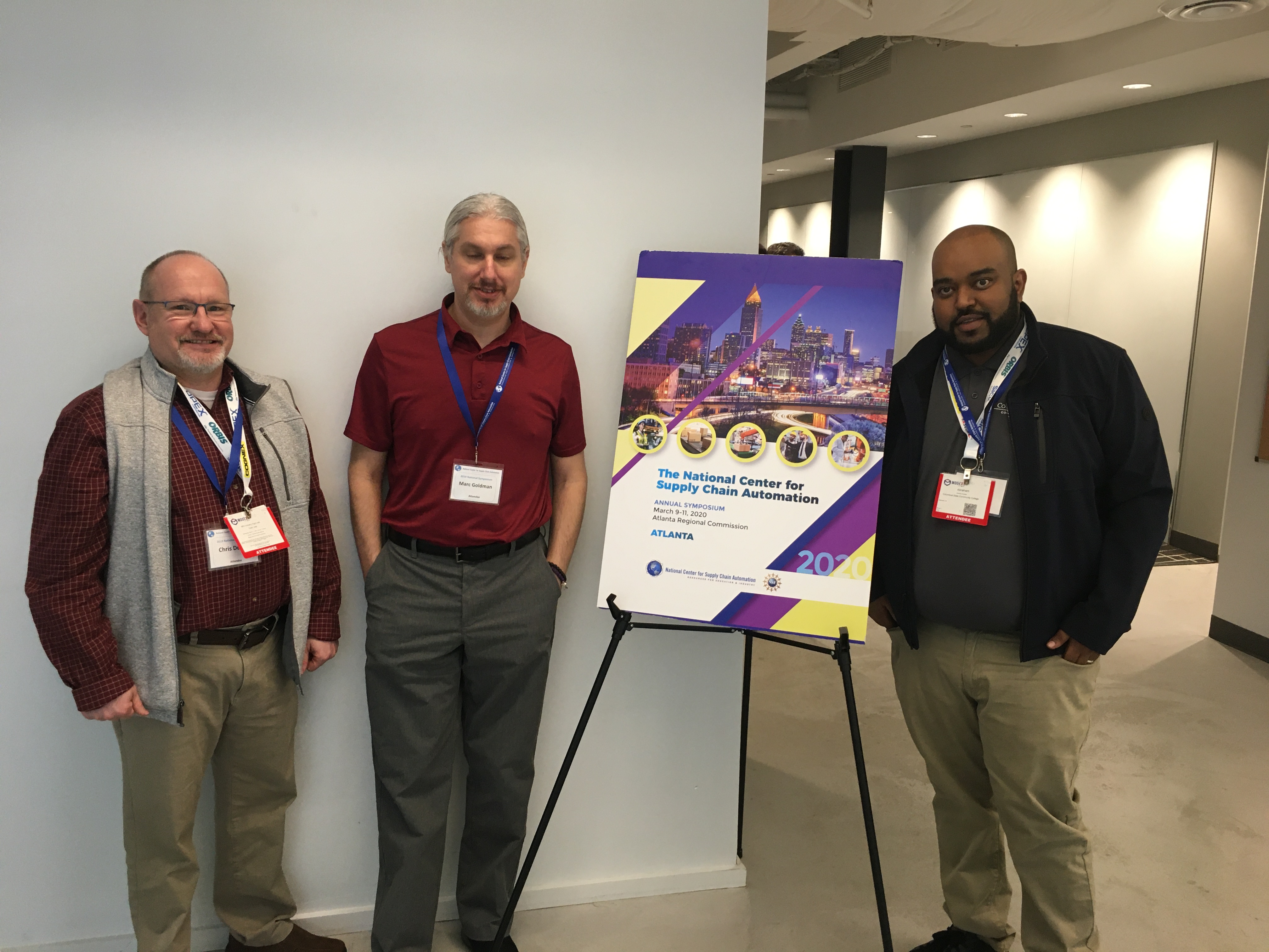 Pictured, LET Instructor Chris Dennis, left, stands next to students Marc Goldman and Abraham Assefaw at the National Center for Supply Chain Automation’s Annual Symposium.