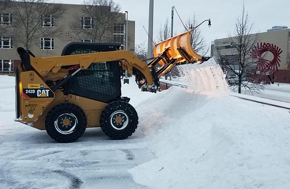 
Robert Osgood clears the 1-E parking lot at the corner of Cleveland Avenue and Grove Street.
